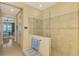 Walk-in shower with glass enclosure and tiled walls at 26852 Faldo Ln, Englewood, FL 34223