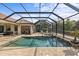 Inviting screened pool and spa with outdoor kitchen at 27429 Hole In One Pl, Englewood, FL 34223