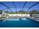 Inviting screened pool with tiled deck, floats, and a fountain feature at 2776 Jacobs St, Port Charlotte, FL 33953