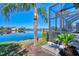 Scenic backyard view with lake access and screened enclosure at 2827 Myakka Creek Ct, Port Charlotte, FL 33953