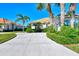 A long driveway leads to a house with palm trees at 2827 Myakka Creek Ct, Port Charlotte, FL 33953