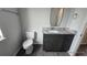 Bathroom with dark vanity and granite countertop at 30072 Alder Rd, Punta Gorda, FL 33982