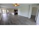 Open living room and kitchen with wood-look tile floors at 30072 Alder Rd, Punta Gorda, FL 33982