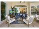Relaxing covered patio with comfortable seating and a view of the backyard at 3117 Silkwood Ln, Port Charlotte, FL 33953