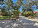 Driveway entrance to home with lush landscaping and mailbox at 3117 Silkwood Ln, Port Charlotte, FL 33953