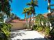 House exterior showcasing garage and tropical landscaping at 3117 Silkwood Ln, Port Charlotte, FL 33953