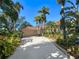 Single-story house with tile roof and palm trees at 3117 Silkwood Ln, Port Charlotte, FL 33953