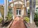 Elegant home exterior featuring a white front door and a terracotta tile walkway at 3117 Silkwood Ln, Port Charlotte, FL 33953