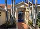 Inviting home exterior with a blue front door, tile walkway, and lush landscaping at 3117 Silkwood Ln, Port Charlotte, FL 33953