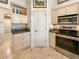Updated kitchen featuring granite countertops and white cabinets at 3117 Silkwood Ln, Port Charlotte, FL 33953