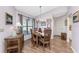 Dining room features wood floors and an oval wooden table with chairs at 313 Pembroke Lane North # 195, Venice, FL 34293