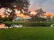 Community sunset view over pond, showcasing waterfront property and landscape at 313 Pembroke Lane North # 195, Venice, FL 34293