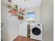 Laundry room with washer, dryer, and shelving at 32 Oakland Hills Ct, Rotonda West, FL 33947