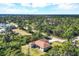 An elevated view of the house reveals its layout, landscaping, and peaceful, wooded surroundings at 4036 Elvington Rd, Port Charlotte, FL 33981
