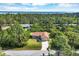 Aerial view of house and surrounding lush landscape at 4036 Elvington Rd, Port Charlotte, FL 33981