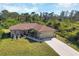 Single-story home with a large yard, driveway, and festive decorations at 4036 Elvington Rd, Port Charlotte, FL 33981