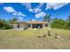 Large backyard showcases a lush green lawn, birdbath, and peaceful surroundings, ideal for relaxation and entertainment at 4036 Elvington Rd, Port Charlotte, FL 33981