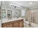Bathroom featuring a double sink vanity with a large mirror and decorative mermaid statue, plus a shower with a curtain at 4036 Elvington Rd, Port Charlotte, FL 33981
