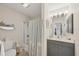 Bathroom showcasing a shower and tub combo, modern gray vanity, and decorative coastal themed accessories, complemented by good lighting at 4036 Elvington Rd, Port Charlotte, FL 33981