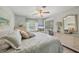 Well-lit bedroom features a queen bed, dresser, and sliding glass door to lanai at 4036 Elvington Rd, Port Charlotte, FL 33981
