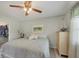 Well-lit bedroom features a queen bed, dresser, and walk-in closet at 4036 Elvington Rd, Port Charlotte, FL 33981