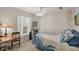 Bright bedroom featuring a bed with blue accents, a ceiling fan, a vintage desk, and a window with white blinds at 4036 Elvington Rd, Port Charlotte, FL 33981