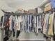 Walk-in closet provides ample storage with hanging racks and shelves for organization of clothing, boxes, and personal items at 4036 Elvington Rd, Port Charlotte, FL 33981