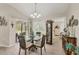 Cozy dining area with chandelier, glass table, and access to the screened lanai at 4036 Elvington Rd, Port Charlotte, FL 33981