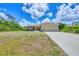 Charming single-story home featuring a two-car garage and well-maintained front yard at 4036 Elvington Rd, Port Charlotte, FL 33981
