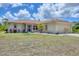 Charming single-story home featuring a two-car garage and well-maintained front yard at 4036 Elvington Rd, Port Charlotte, FL 33981