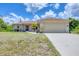 Charming single-story home featuring a two-car garage and well-maintained front yard at 4036 Elvington Rd, Port Charlotte, FL 33981