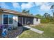 Exterior view of house with screened porch and landscaped yard at 4036 Elvington Rd, Port Charlotte, FL 33981