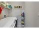 Laundry room with a white washer and dryer, shelving with laundry supplies, and a 'Laundry' sign on the wall at 4036 Elvington Rd, Port Charlotte, FL 33981