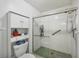 Clean bathroom with a walk-in shower and a storage cabinet at 520 Pine Hollow Cir # 520, Englewood, FL 34223