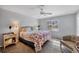 Spacious bedroom with a king-size bed and ceiling fan at 520 Pine Hollow Cir # 520, Englewood, FL 34223