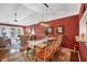 Elegant dining room with a six-chair table and terracotta walls at 520 Pine Hollow Cir # 520, Englewood, FL 34223