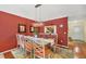 Charming dining area with a glass-top table and terracotta walls at 520 Pine Hollow Cir # 520, Englewood, FL 34223