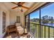 Bright sunroom with lake view and wicker furniture at 520 Pine Hollow Cir # 520, Englewood, FL 34223