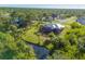 Aerial view showcasing the home's private backyard and canal at 6096 Bowie Ln, Englewood, FL 34224