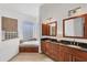 Elegant bathroom with double vanity and soaking tub at 6096 Bowie Ln, Englewood, FL 34224