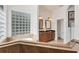Double vanity bathroom with a large soaking tub and separate shower at 6096 Bowie Ln, Englewood, FL 34224