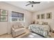 Bedroom with a queen bed, couch, and window with bamboo shades at 6096 Bowie Ln, Englewood, FL 34224