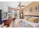 King-size bed and large TV in well-lit bedroom at 6096 Bowie Ln, Englewood, FL 34224
