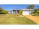 House exterior with a two-car garage at 6096 Bowie Ln, Englewood, FL 34224