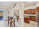 Open kitchen with granite counters and breakfast bar, overlooking the pool at 6096 Bowie Ln, Englewood, FL 34224