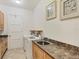 Laundry room with washer, dryer, cabinets, and a utility sink at 6096 Bowie Ln, Englewood, FL 34224