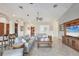 Bright and airy living room with a large TV and comfortable seating at 6096 Bowie Ln, Englewood, FL 34224