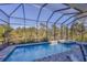 Inviting swimming pool with spa and screened enclosure at 6096 Bowie Ln, Englewood, FL 34224