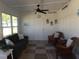 Cozy sunroom with seating area and ceiling fan at 6156 Redwing Ave, Englewood, FL 34224