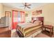 Cozy bedroom with striped bedding, window, and ceiling fan at 6358 Granger Rd, Port Charlotte, FL 33981